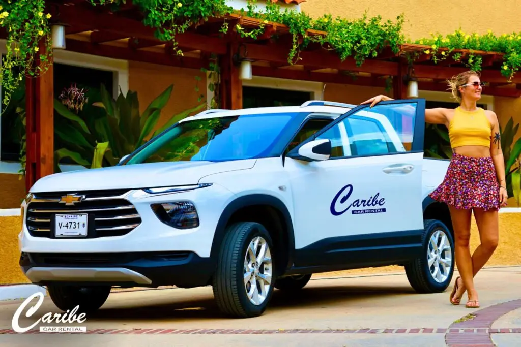 Deluxe rental car chevrolet pickup front right view with women next to it