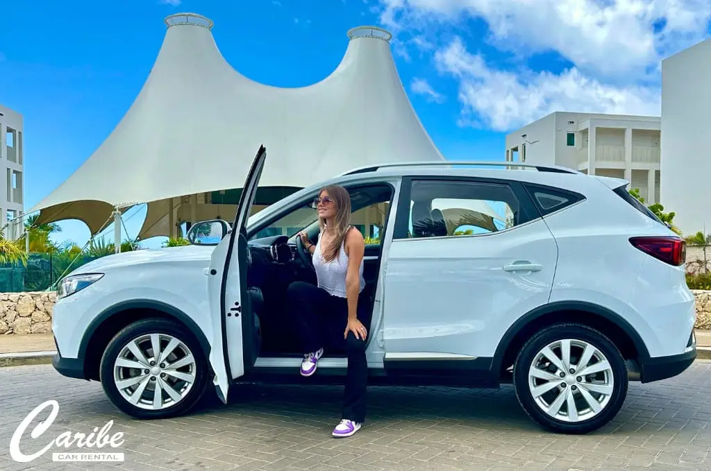 Car rental MG crossover bonaire right side view women getting out of the car